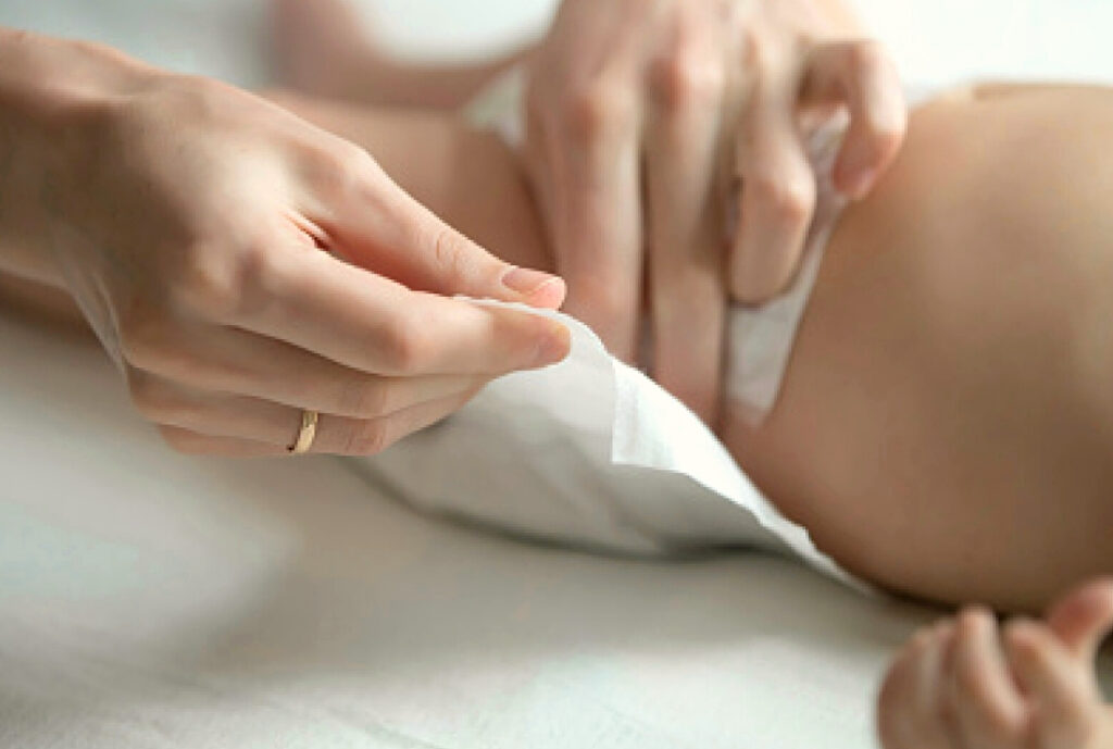 Mom changing diapers with baby
